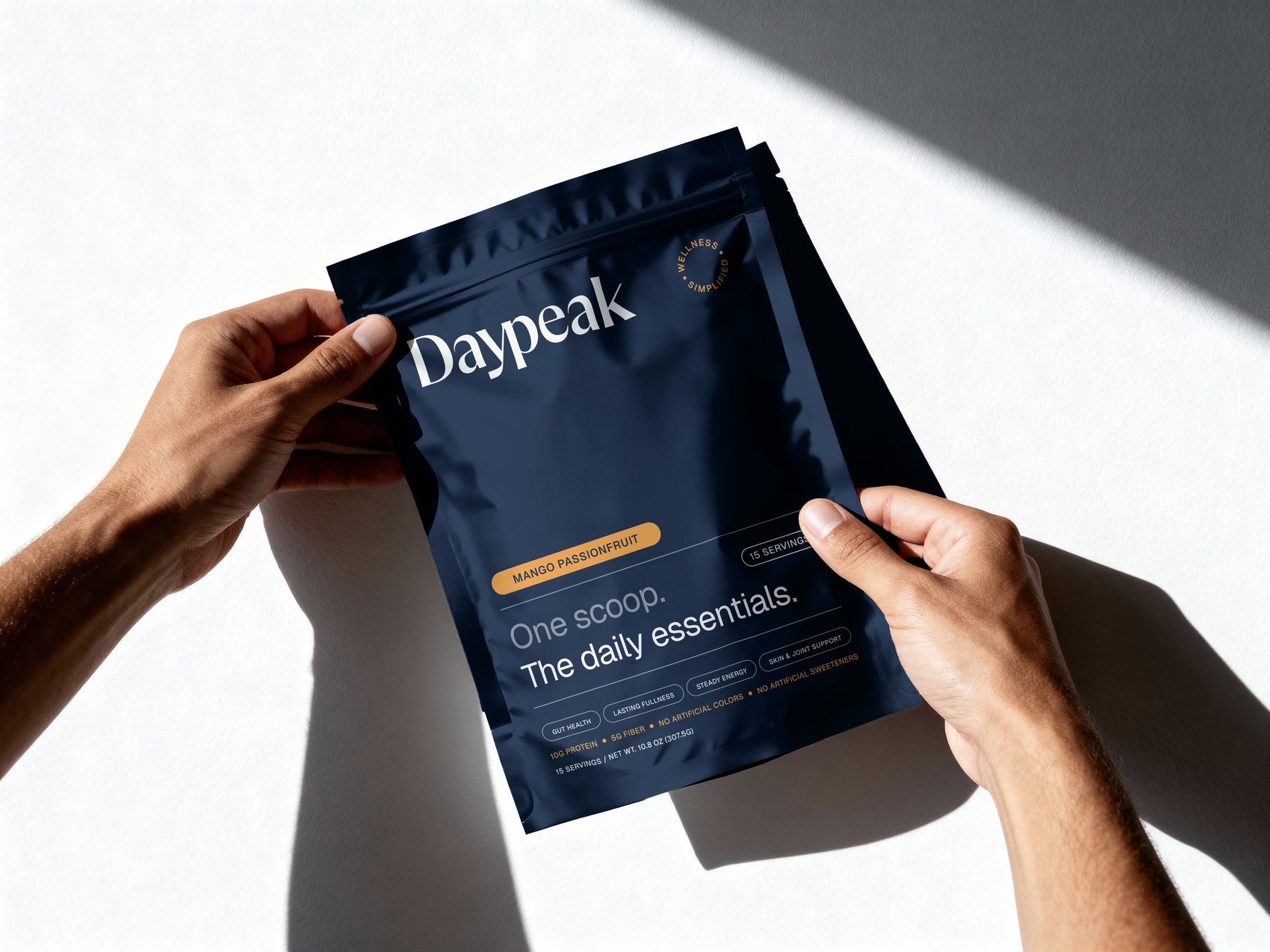 Hands holding a Mango Passionfruit Daypeak pouch
